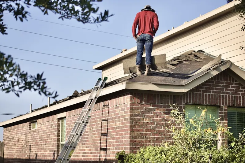Professional roofer working on a residential roof in Holly Landing